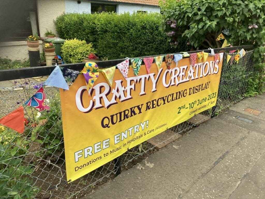 A sign advertising 'Crafty Creations - Quirky Recycling Display'.