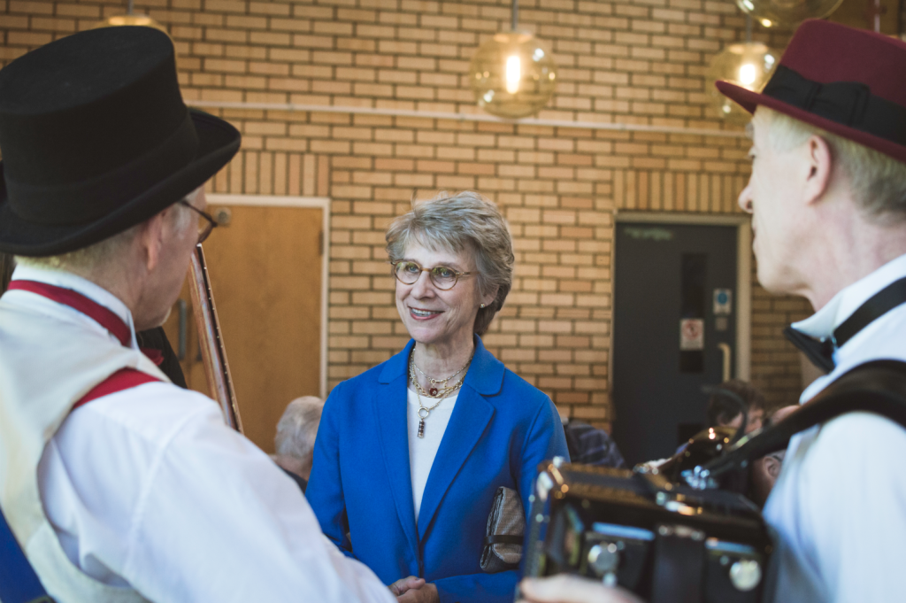 Music in Hospitals & Care royal patron speaking with musicians during a live performance visit.