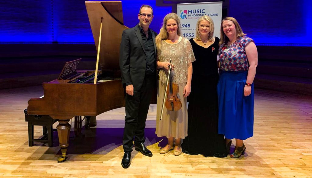 Music in Hospitals & Care Presidents and Vice Presidents standing together on stage after a live music performance.